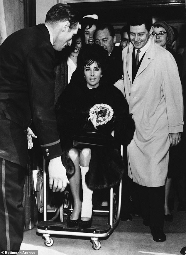 خضعت نجمة هوليوود إليزابيث تايلور لعملية جراحية في الركبة في عيادة لندن في يناير 1963. أعلاه: تايلور تغادر المستشفى وساقها مغطاة بالضمادات