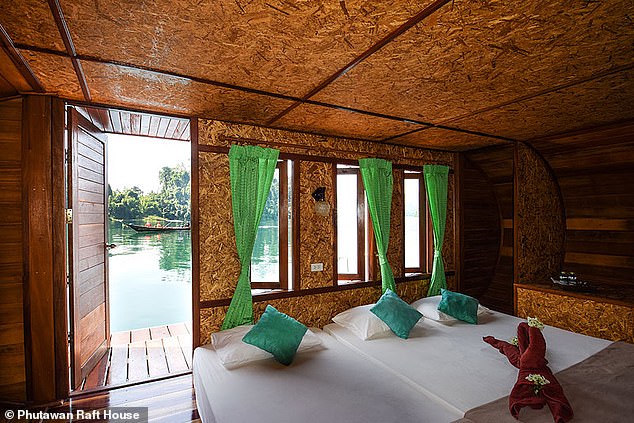 أعلاه إحدى كبائن الكبسولة في Phutawan Raft House.  تحتوي كل غرفة على تراس صغير خاص بها، ولكن لا يوجد حمام