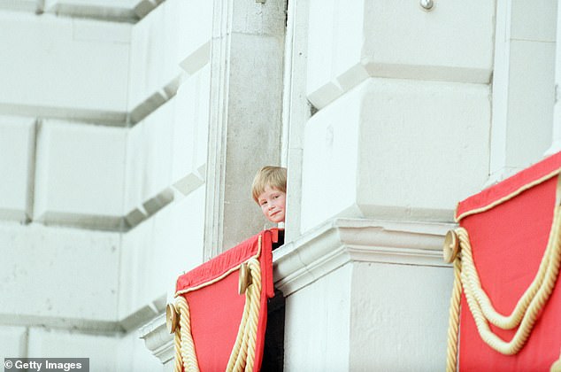 الأمير هاري ينظر من نافذة في قصر باكنغهام خلال فرقة الألوان في يونيو 1990