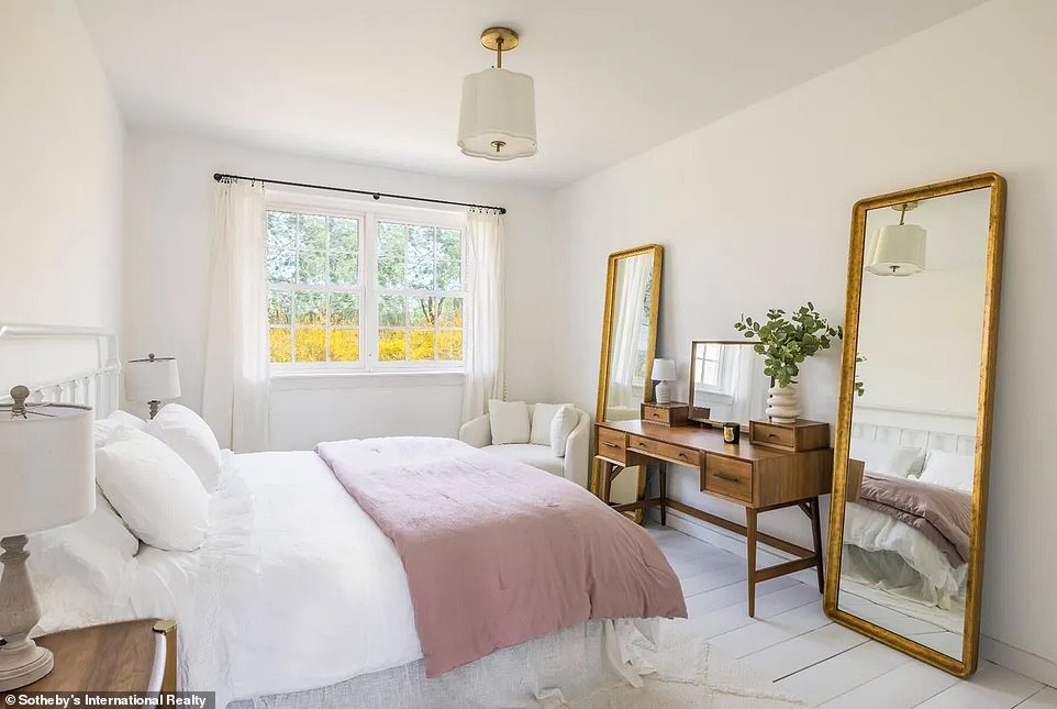 تم تصميم إحدى غرف النوم بالكامل تقريبًا باللون الأبيض، بدءًا من العوارض الخشبية ومروحة السقف وحتى الأرضيات والجدران وإطار النوافذ.